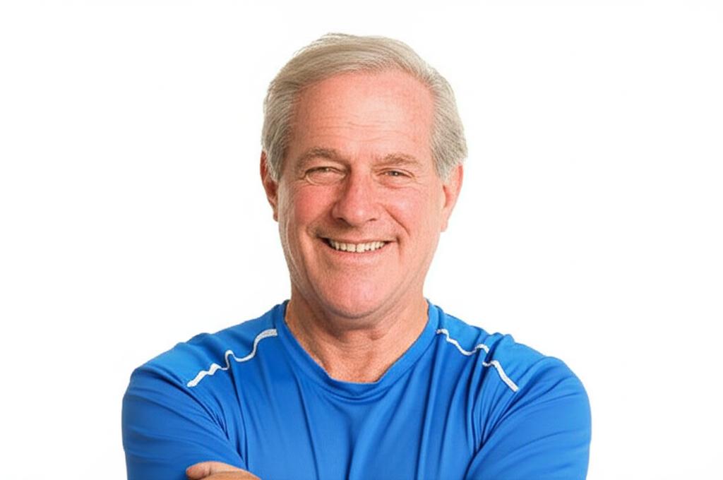 Middle-aged man smiling confidently, looking energetic, maybe exercising lightly, realistic photo
