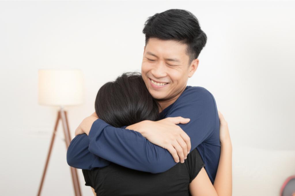 Man feeling relieved and happy, embracing his partner